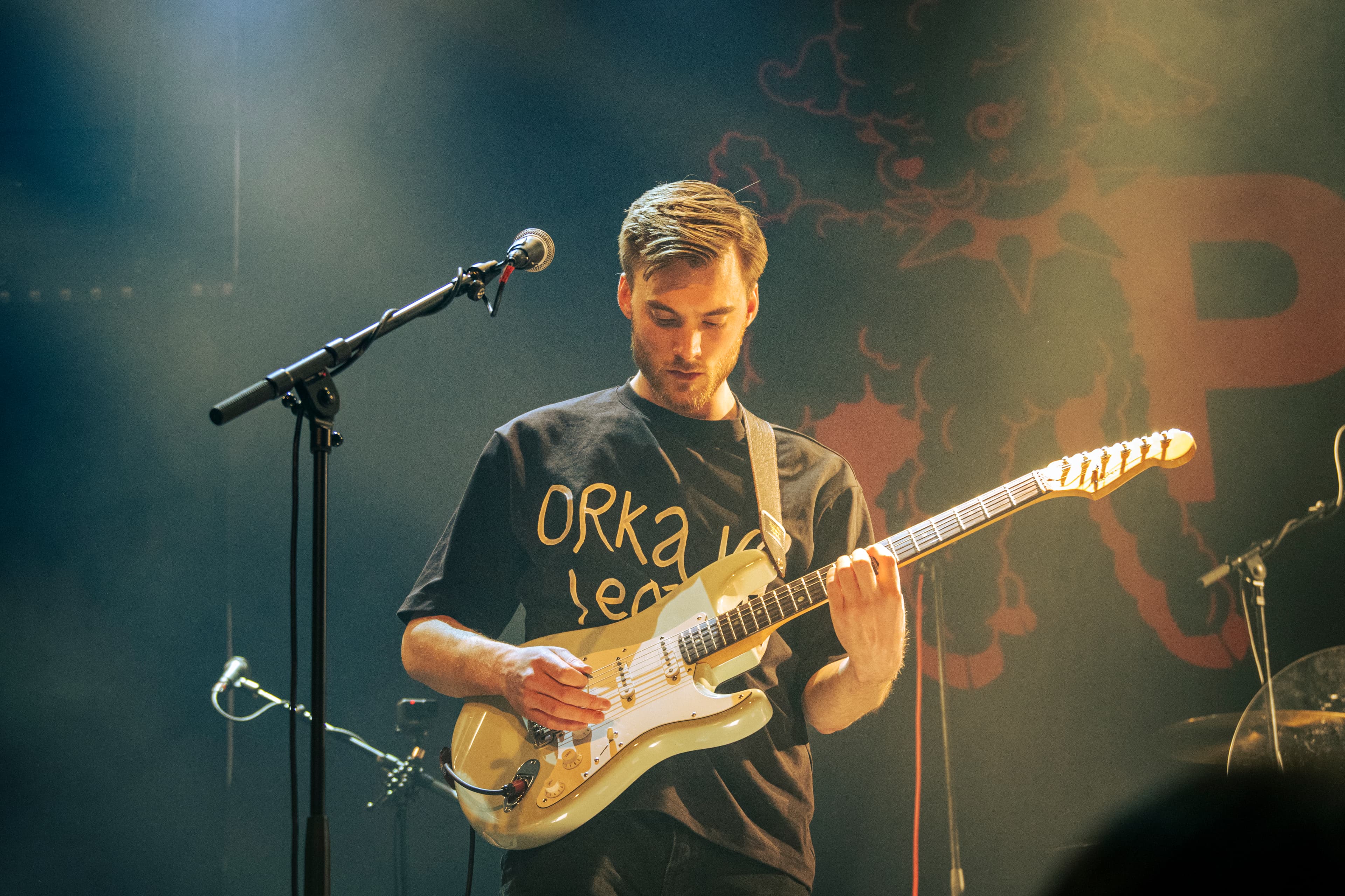Marcus performing guitar on stage